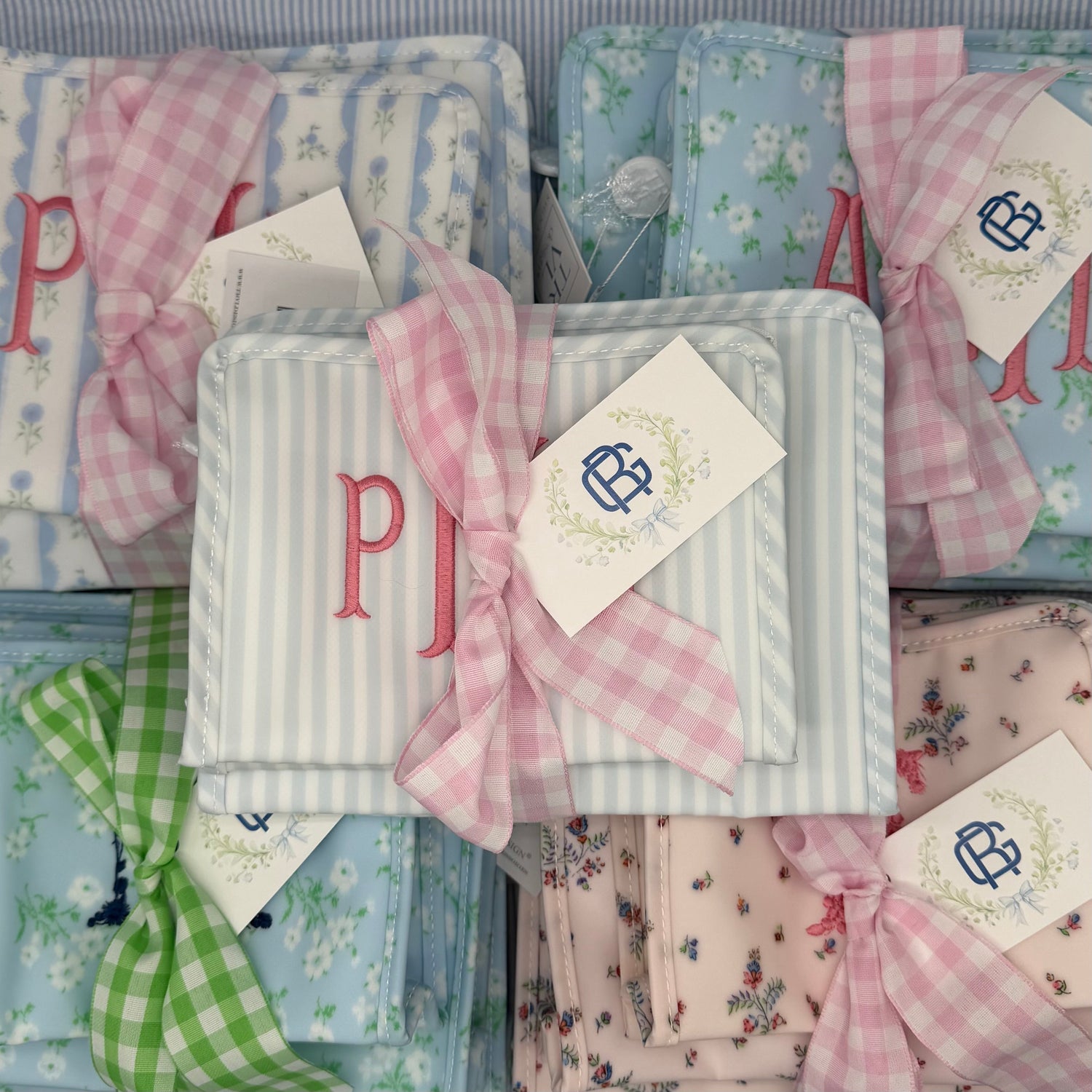 Monogrammed TRVL Design Roadie bags with gingham bows
